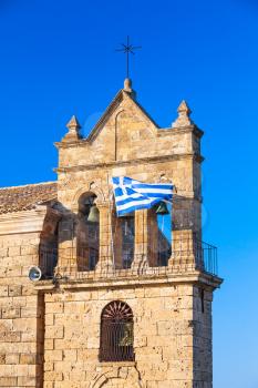 Greek flag on Church of Saint Nicholas Molou on Solomos Square. Zakynthos, Greek island in the Ionian Sea