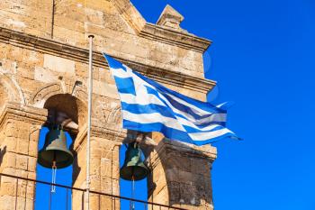 Waving Greek flag on Church of Saint Nicholas of Mole on Solomos Square. Zakynthos, Greek island in the Ionian Sea