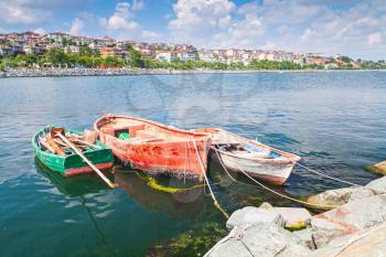 Three old wooden fishing boats moored in small port of Avcilar, Istanbul, Turkey