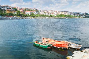Three old wooden fishing boats moored in port of Avcilar, Istanbul, Turkey