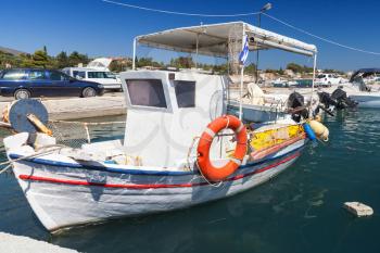 White wooden fishing boat moored in port of Agios Sostis village. Zakynthos, Greek island in the Ionian Sea