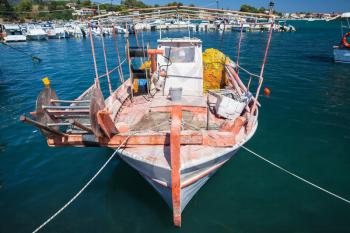 Front view of old wooden fishing boat moored in port of Agios Sostis village. Zakynthos, Greek island in the Ionian Sea