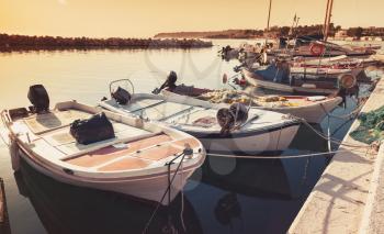 Old wooden fishing boats moored in bay of Tsilivi. Zakynthos, Greek island in the Ionian Sea. Warm tonal correction filter effect, old instagram style