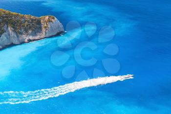 Fast motor boat goes on Navagio Bay. The most famous nature landmark of Greek island Zakynthos in the Ionian Sea