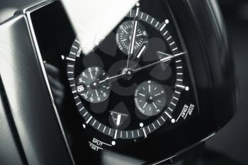 Mens chronograph wirstwatch made of high-tech ceramics with sapphire glass over black background. Macro photo with selective focus