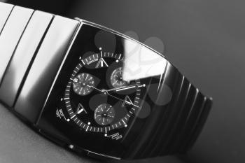 Mens chronograph watch made of high-tech ceramics with sapphire glass over black. Selective focus