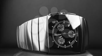 Mens chronograph watch made of high-tech ceramics with sapphire glass over black background. Closeup photo, selective focus
