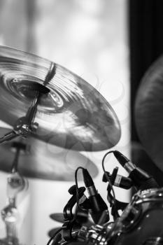 Cymbals as a part of drum set. Black and white photo with soft selective focus