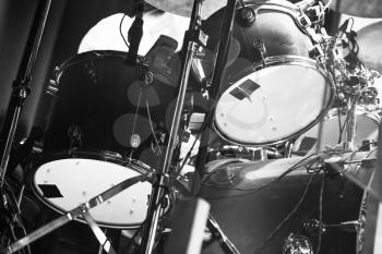Black and white photo of drum set, rock music background