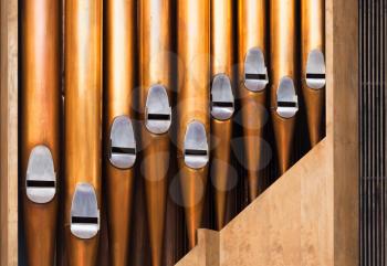 Closeup photo of shining organ tubes, classical music background photo