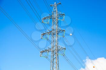 Lattice-type steel tower as a part of high-voltage line. Overhead power line details. The structure used to transmit electrical energy in electric power transmission and distribution