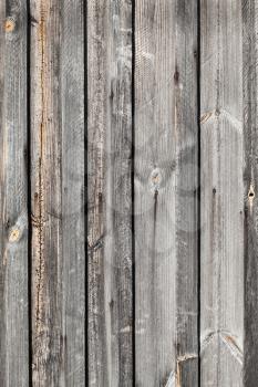 Old gray weathered wooden wall, vertical background photo texture