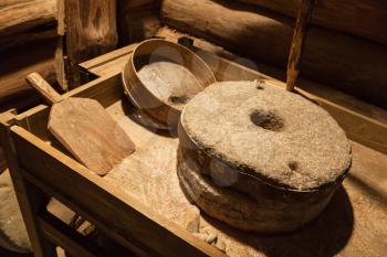 Old millstones for grinding grain, vintage farming tools