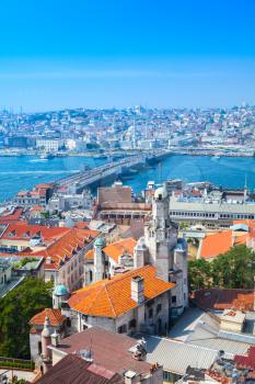 Istanbul, Turkey. Summer cityscape with bridge over Golden Horn a major urban waterway and the primary inlet of the Bosphorus. Vertical photo taken from upper viewpoint of Galata tower