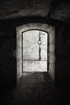 Abandoned military bunker interior with concrete walls and empty doorway