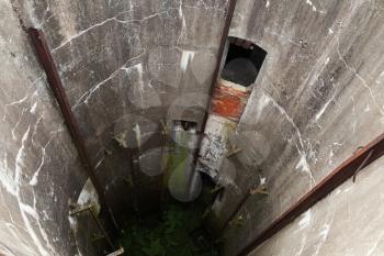 Abandoned military silo. Grunge concrete tunnel interior