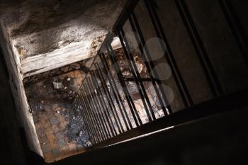 Old empty abandoned bunker interior with rusted metal ladder going down