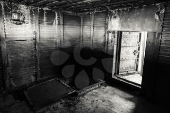 Abstract dark grungy industrial interior with metal walls and open heavy steel door