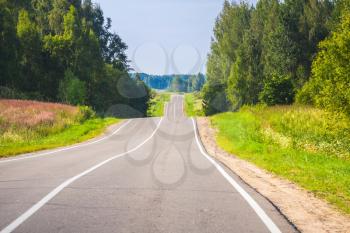 Empty rural highway perspective in summer day, European road landscape