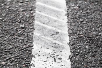 White dividung line with tire tracks, highway road marking. Abstract transportation background