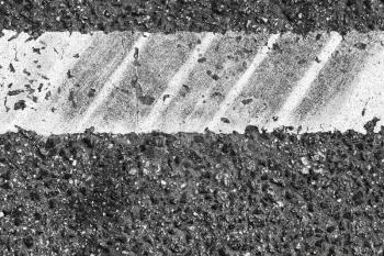 White dividung line fragment with tire tracks over it, highway road marking. Abstract transportation background