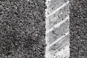 Dividing line with tire track over it, highway road marking fragment. Abstract transportation background