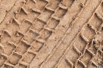 Truck tire track on wet sand, abstract transportation background texture
