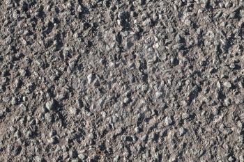 Tarmac. Dark road pavement consisting of crushed rock mixed with tar. Close-up background photo texture