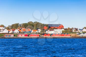 Colorful wooden houses on sea coast. Brekstad, Norway