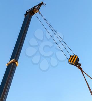 Telescopic mobile crane boom with hook and chain