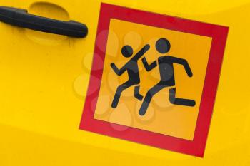 Square yellow Сaution children transportation sign in red frame, sticker on school minivan door