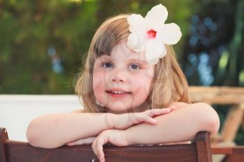 Cute happy Caucasian little girl, close-up outdoor portrait