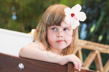 Serious Cute Caucasian little girl, close-up outdoor portrait