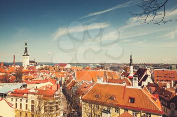 Old town of Tallinn panorama. Churches and living houses with red roofs, vintage toned photo, old style filter effect