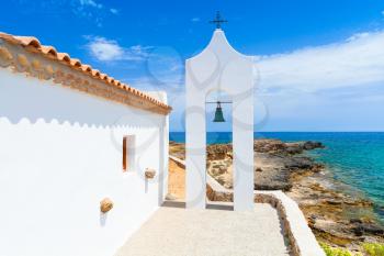 Agios Nikolaos. Small white Orthodox bell tower arch near church. Coast of island Zakynthos, Greece