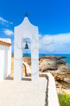 Agios Nikolaos. Small white Orthodox bell tower near church. Coast of island Zakynthos, Greece