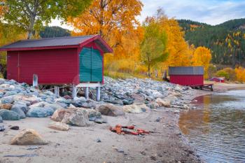 Norwegian Sea coast, autumn landscape with red wooden barns for fishing boats storage. Trondheim region