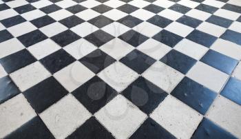 Retro stone floor tiling with black and white checkered pattern