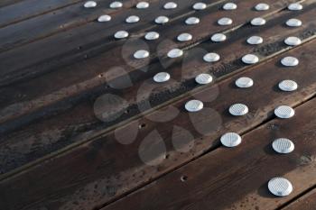 Outdoor wooden flooring with steel anti-slip buttons