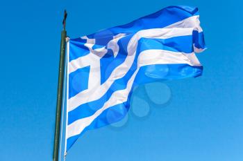 Flag of Greece wavin gover blue sky background