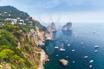 Capri island, Italy. Mediterranean Sea coast. Coastal landscape with rocks and many pleasure yachts 