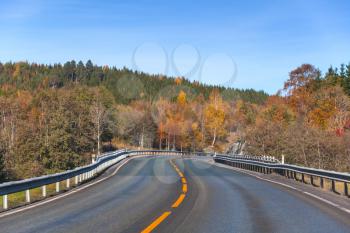 Turning rural Norwegian highway in autumn season