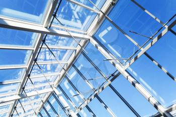 Modern high-tech architecture background, internal structure of glass roof with lockable windows sections