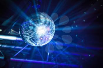 Disco ball with blue rays, night party background photo