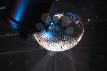 Disco ball near spot light, night party background photo