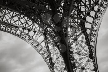 Eiffel tower bearing fragment, the most popular landmark of Paris, France. Monochrome photo with retro style effect
