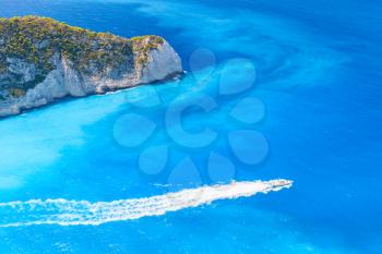 Pleasure motor boat goes on Navagio Bay. The most famous nature landmark of Greek island Zakynthos in the Ionian Sea