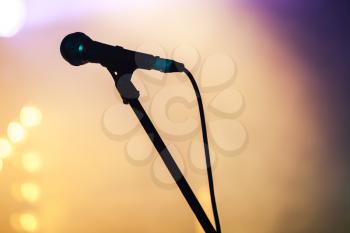 Professional stage microphone over blurred colorful background