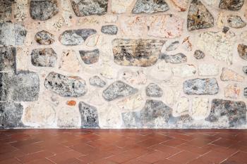 Abstract interior background, gray stone wall and red floor tiling