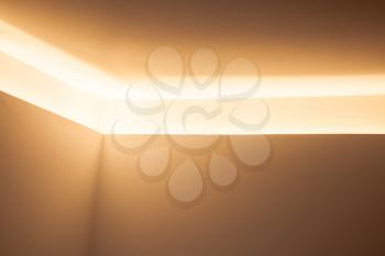 Abstract contemporary architecture background, design of room corner with horizontal niche and bright inner illumination